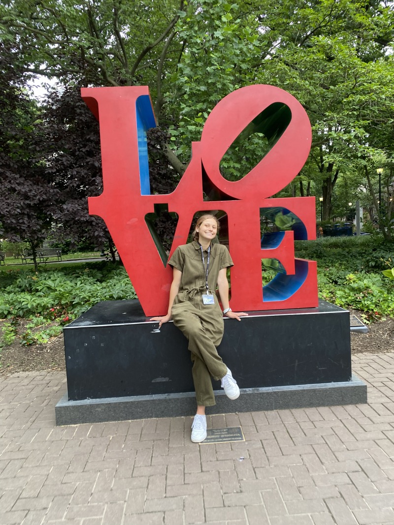 Hallie Kern sitting in front of the LOVE sign 