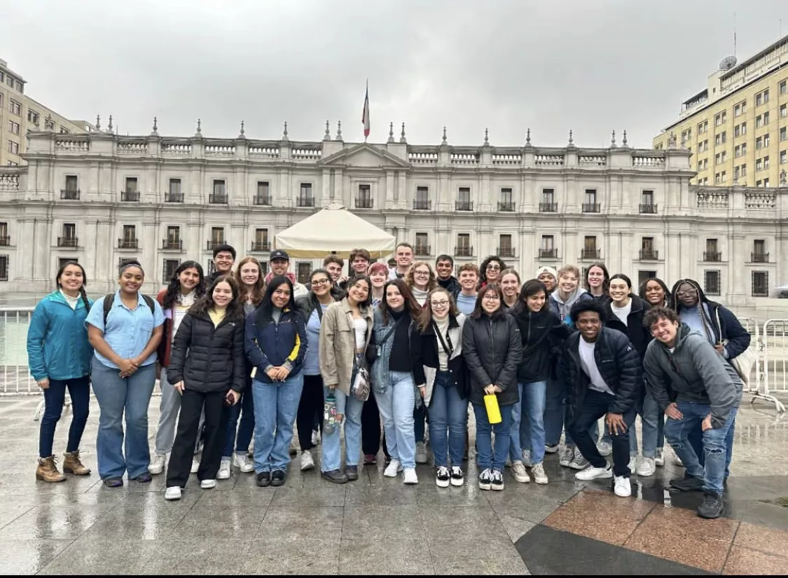 Group photo in front of a palace. 