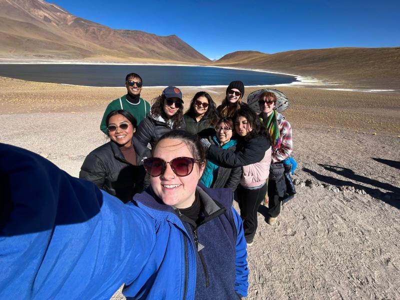 Group selfie in front of a lake.