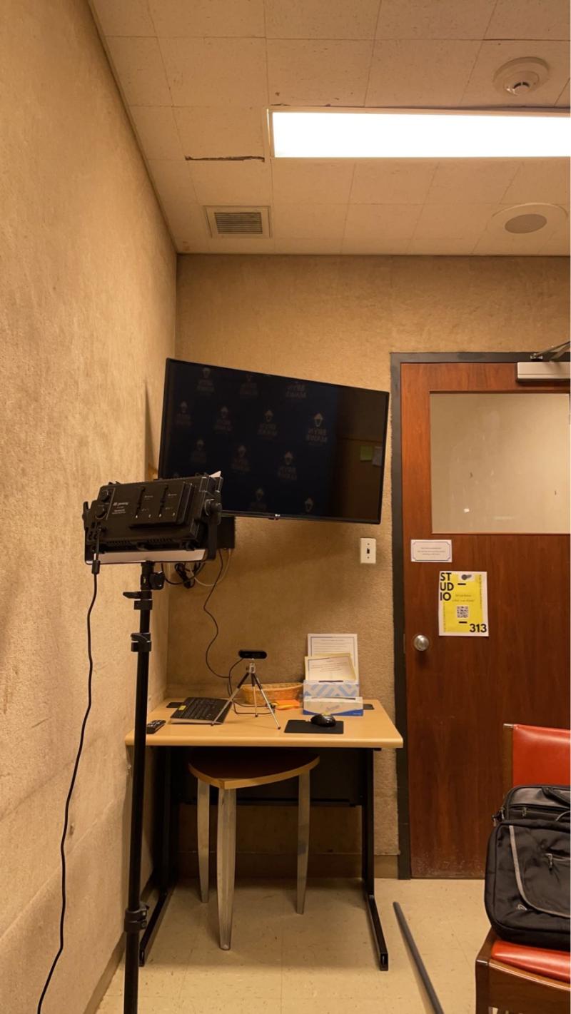 Classroom with a TV and desk.