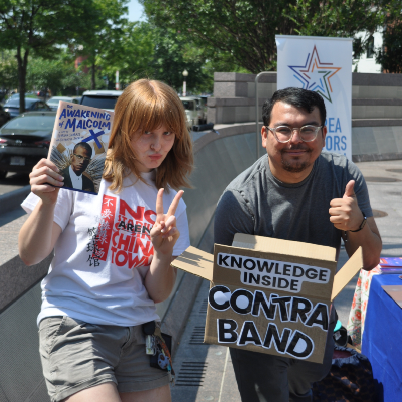 Two people holding signs. 