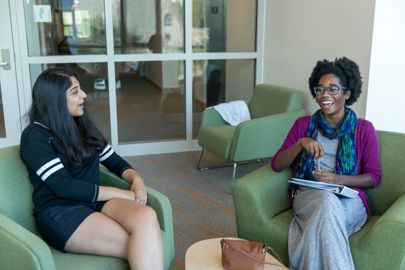 Two Students sitting and talking