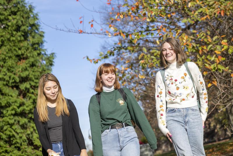 Three students walking on campus