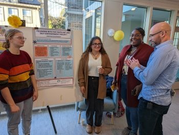 Students with community mentors at the Praxis poster session