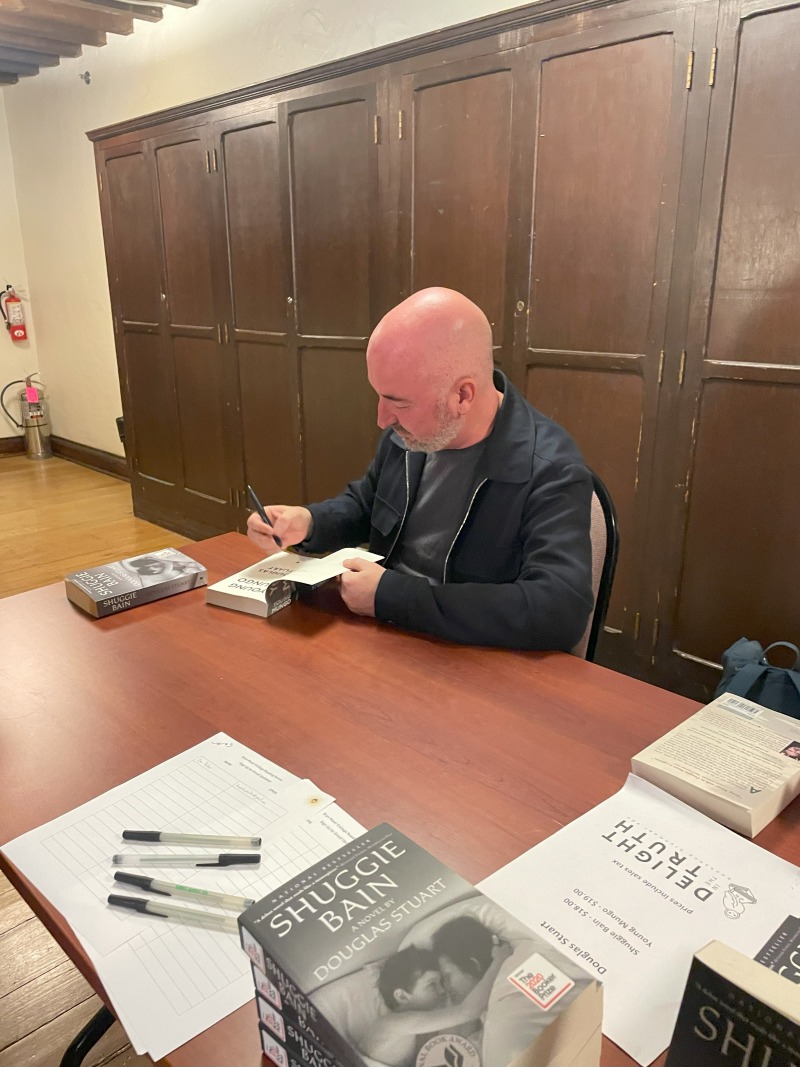 Author signing books at the Bryn Mawr Reading Series