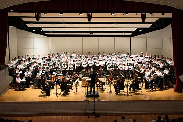 An image of the Bi-Co Chorale - a group of singers with a full orchestra