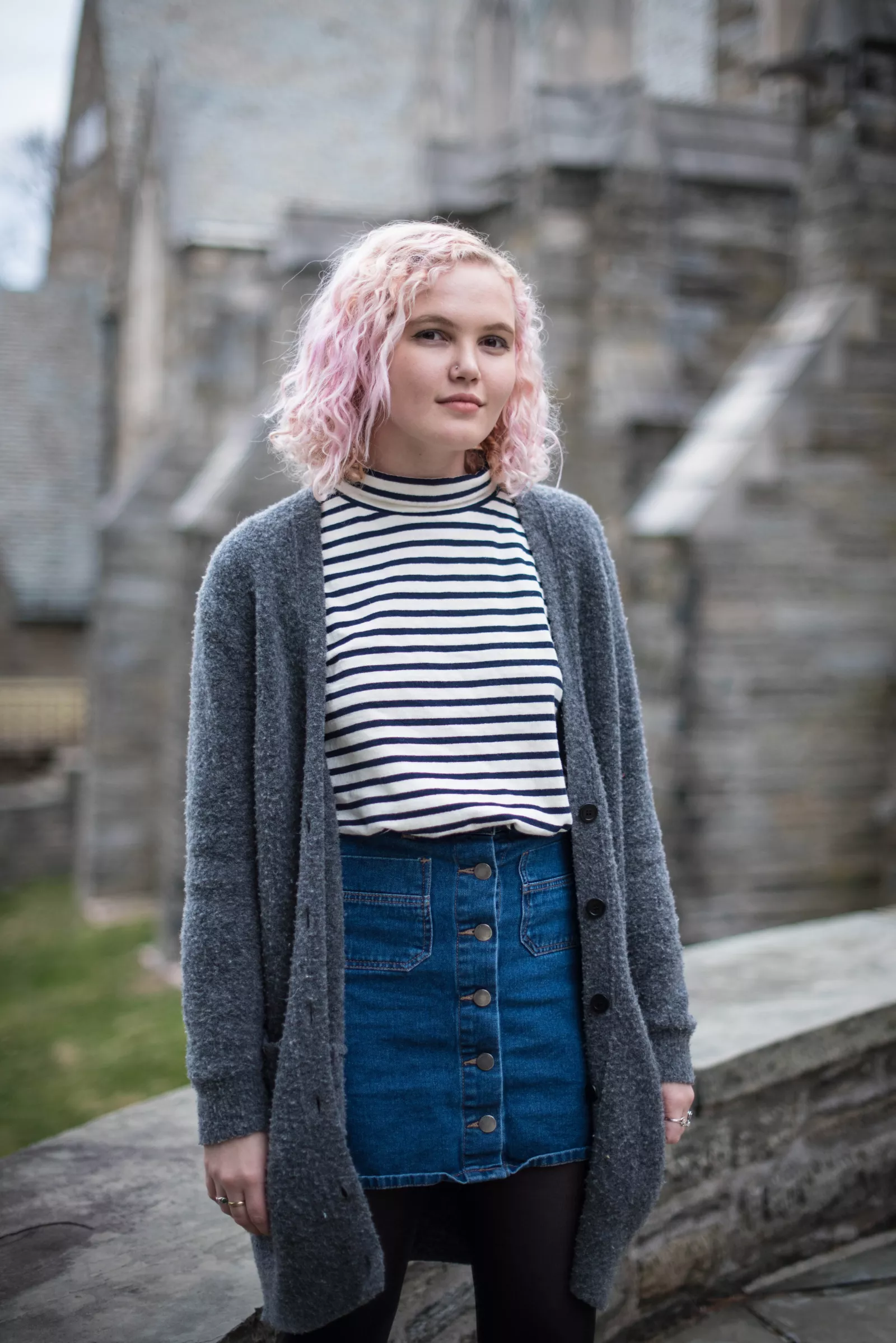 Delia stands in front of stone wall