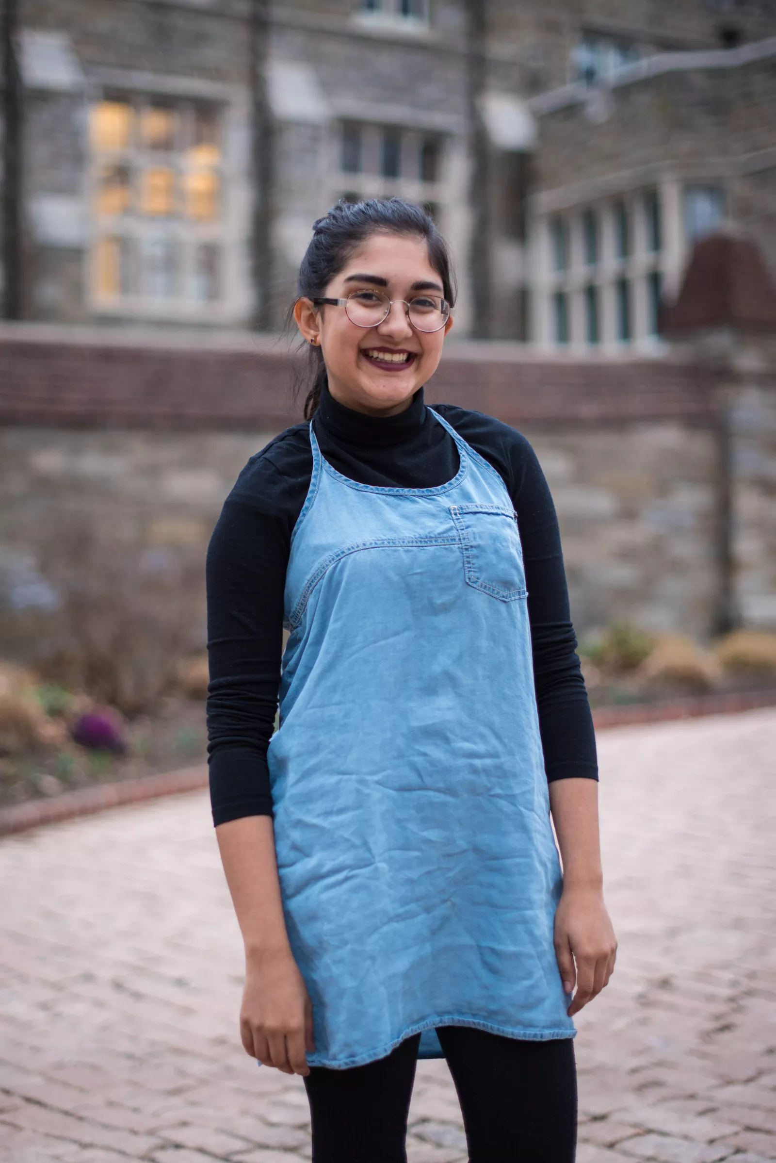 Swati stands on cobblestones