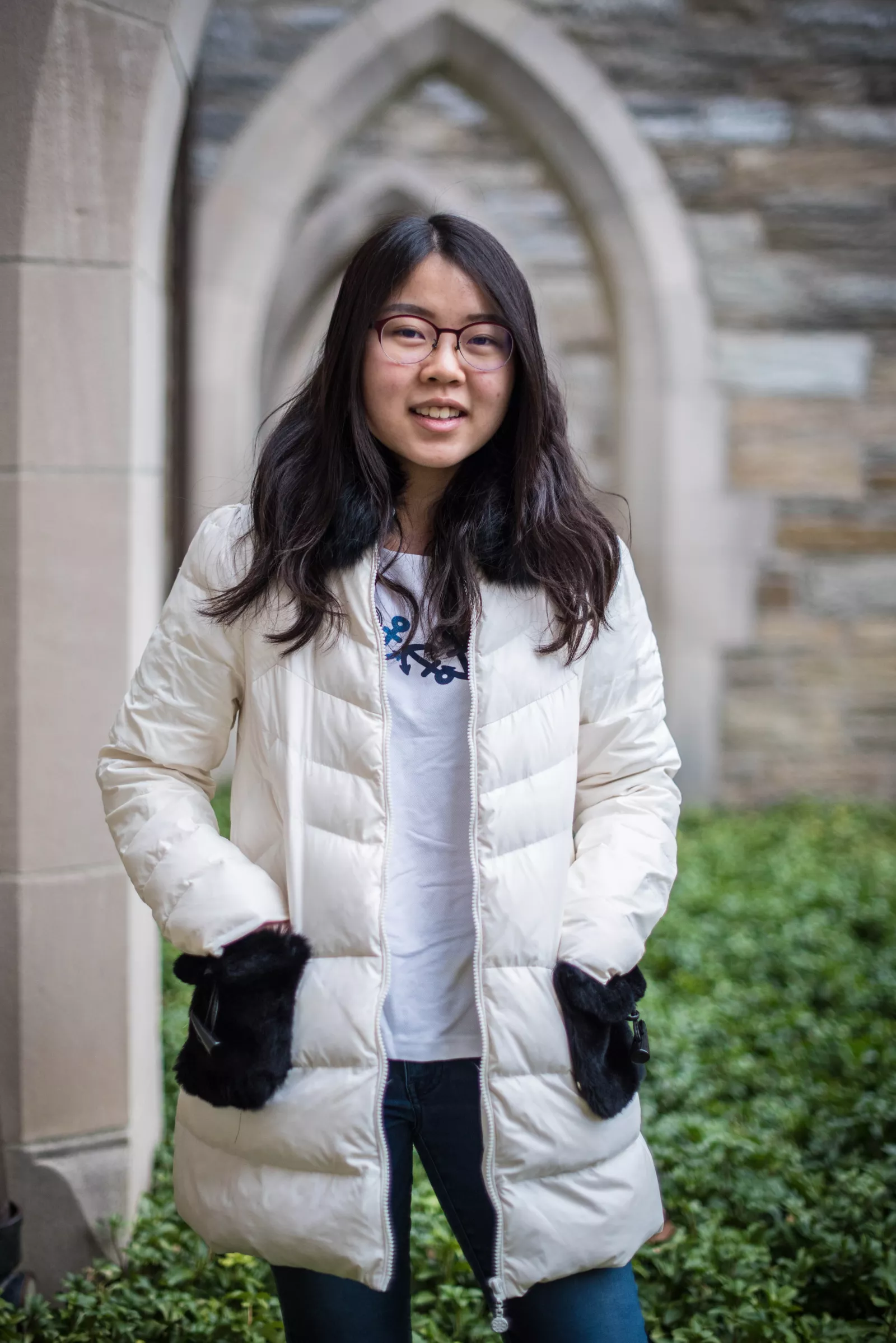 Anna stands in front of stone arches