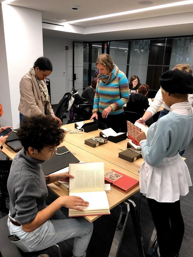 Lecturer Cordelia Jensen (center) and students at the NYU Bobst Library